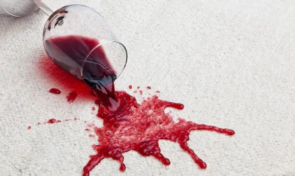 spilled wine on a white carpet